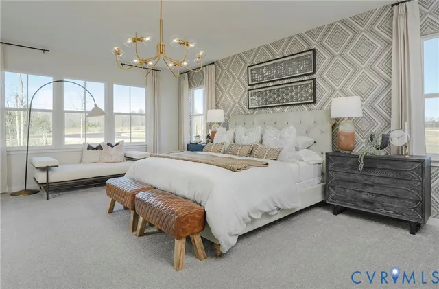 a spacious bedroom with a bed and a chandelier