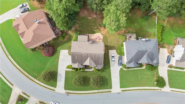 an aerial view of a house with garden space and street view