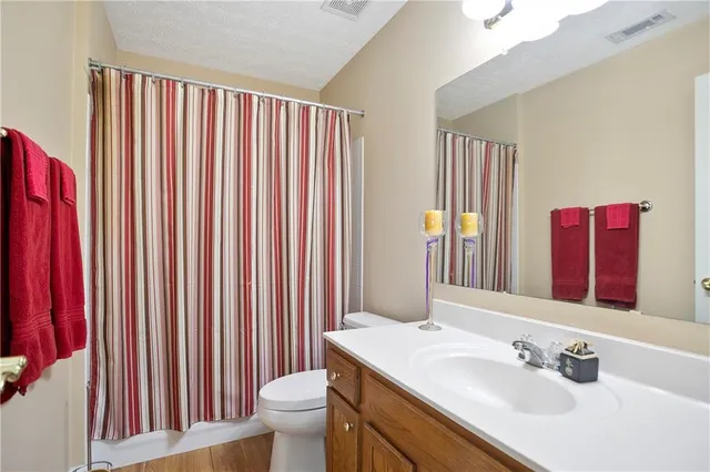 a bedroom with a bed and ceiling fan