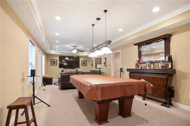 a kitchen with granite countertop a refrigerator and a stove top oven
