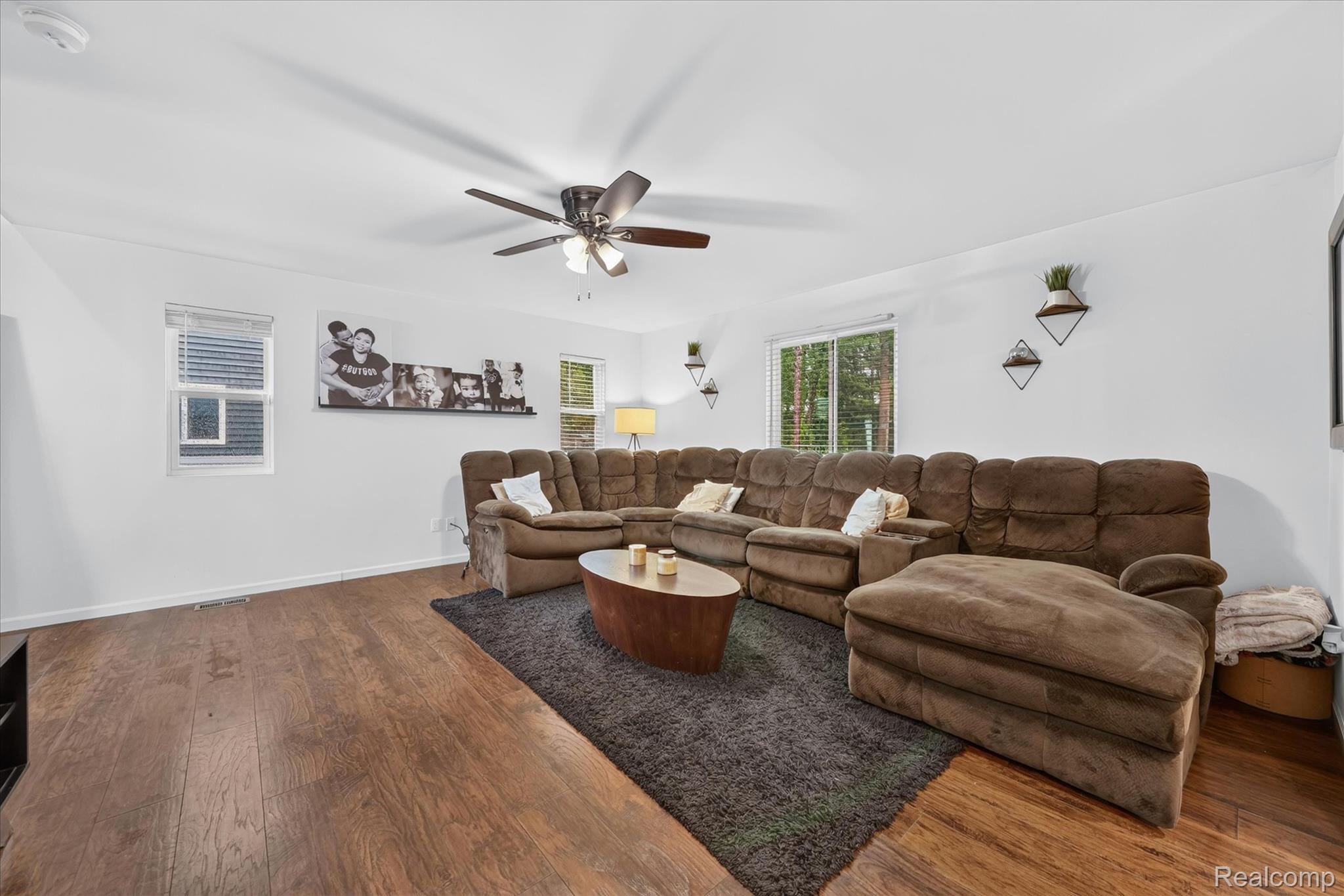 5382 Rural Terrace Waterford, MI 48329 - Photo 8 of 35 Bright living space featuring wood-finish flooring, white walls, multiple windows, and a ceiling fan