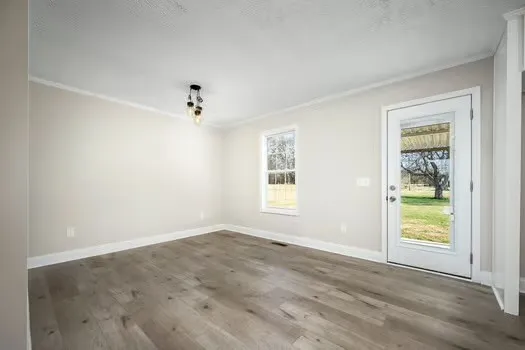 an empty room with windows and closet