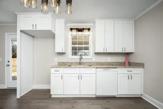 a kitchen with stainless steel appliances granite countertop a sink and dishwasher with wooden floor
