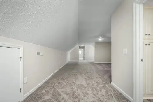 a view of a big room with closet and windows