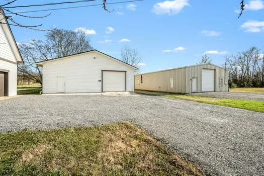 a view of garage and wooden fence