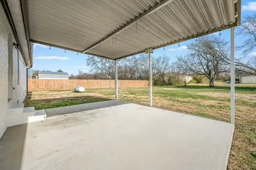a view of a field with an trees