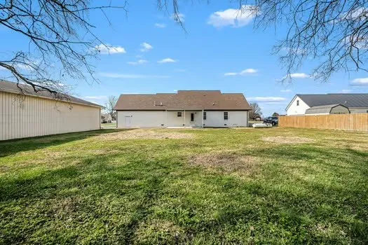 a view of an house with backyard space and garden