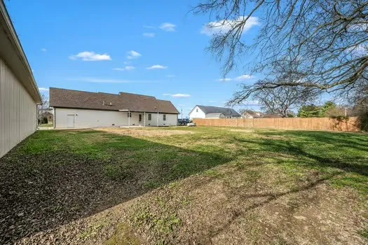 a view of a house with a yard and garage
