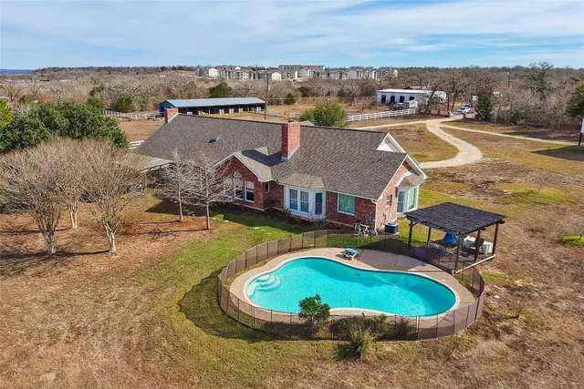 a swimming pool with outdoor seating and yard