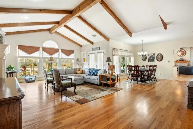 a living room with lots of furniture and wooden floor