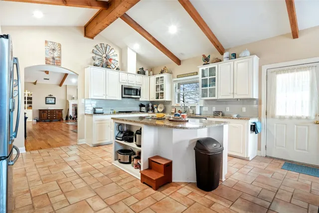 a kitchen with a stove a sink and a refrigerator