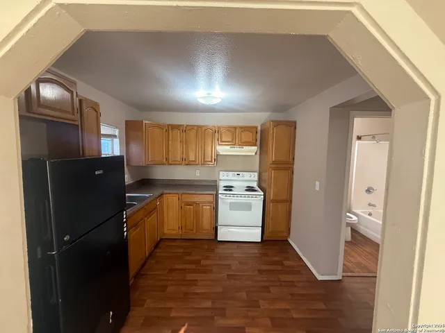 a kitchen with a white cabinets and white appliances