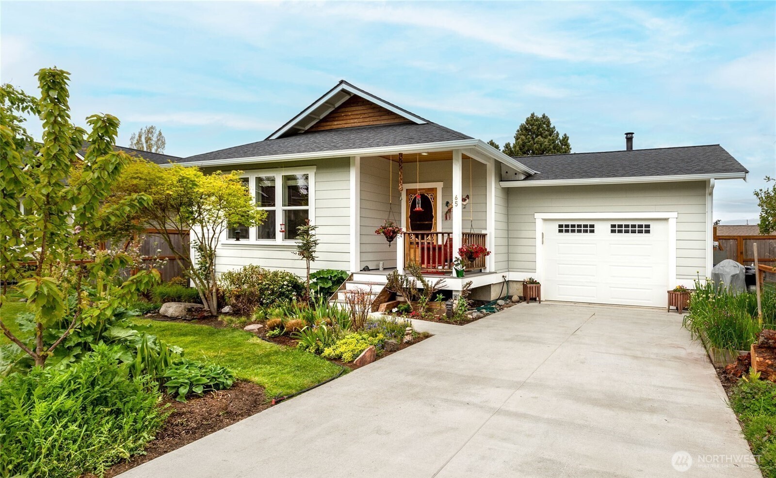 65 Gerard Lane Friday Harbor, WA 98250 - Photo 1 of 21 a front view of a house with a garden and sitting area