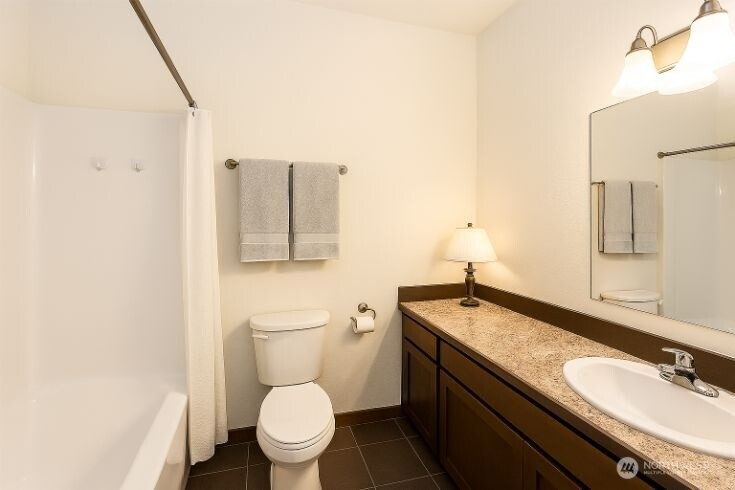 65 Gerard Lane Friday Harbor, WA 98250 - Photo 10 of 21 a bathroom with a granite countertop sink a large mirror and toilet