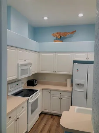 a kitchen with a sink a stove and cabinets