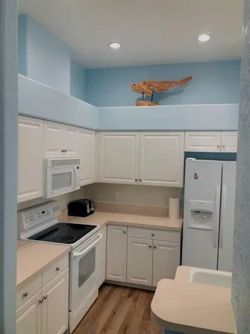 a kitchen with a sink a stove and cabinets
