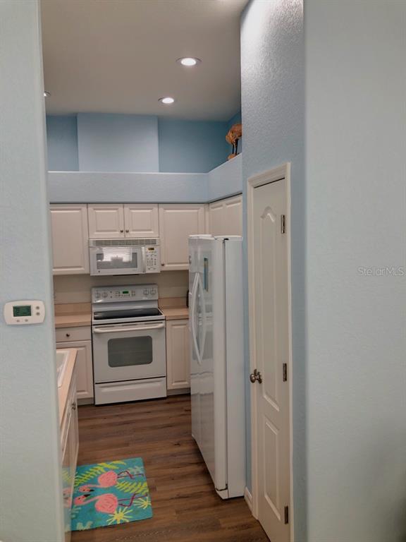 1211 Hot Springs Point Englewood, FL 34223 - Photo 12 of 30 a kitchen with stainless steel appliances a stove and a refrigerator