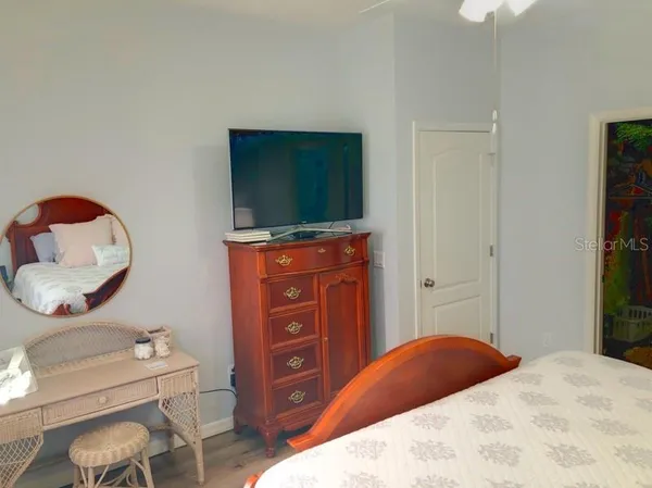 a bedroom with a bed and a television