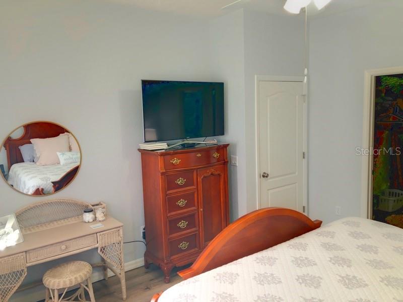 1211 Hot Springs Point Englewood, FL 34223 - Photo 16 of 30 a bedroom with a bed and a television