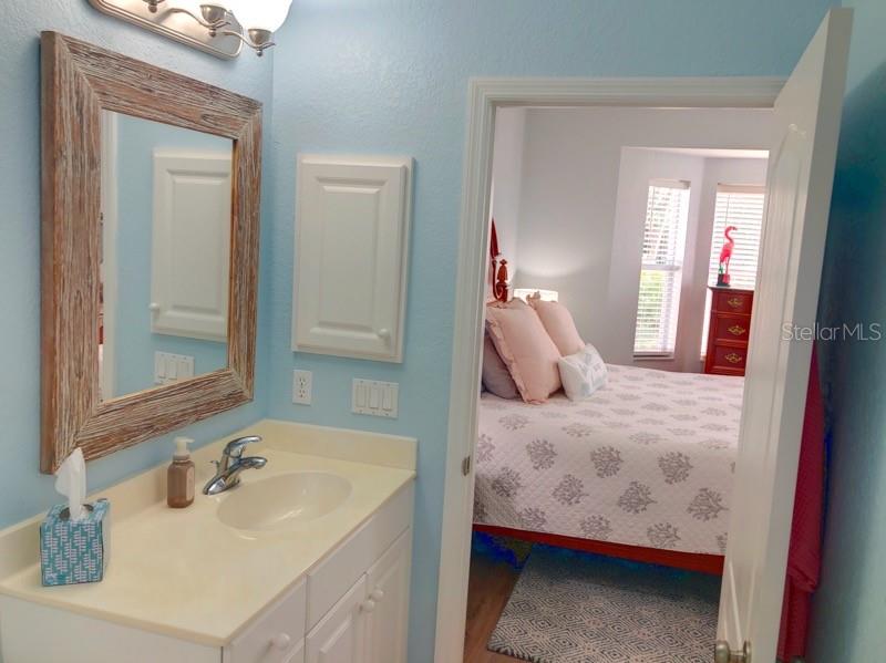 1211 Hot Springs Point Englewood, FL 34223 - Photo 18 of 30 a en suite bathroom with a sink and mirror