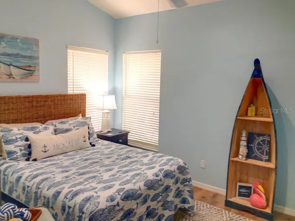 a bedroom with a bed and a painting on the wall