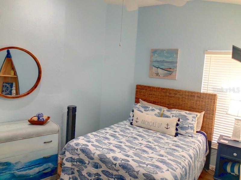 1211 Hot Springs Point Englewood, FL 34223 - Photo 21 of 30 a bedroom with a bed and a painting on the wall