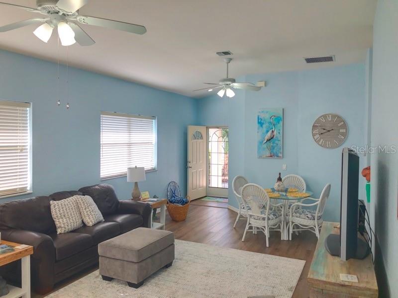 1211 Hot Springs Point Englewood, FL 34223 - Photo 5 of 30 a living room with furniture and a chandelier