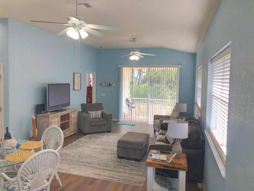 1211 Hot Springs Point Englewood, FL 34223 - Photo 7 of 30 a living room with furniture fireplace and a large window