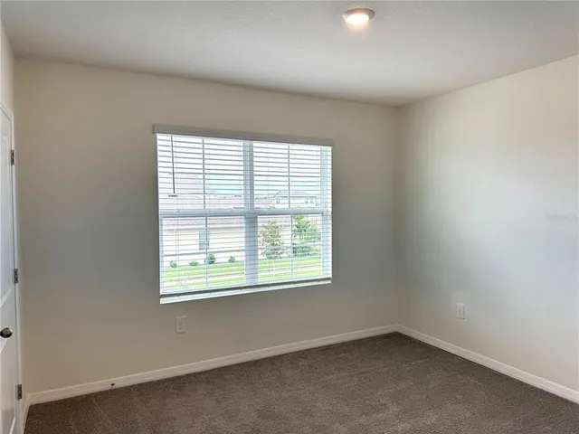 a bathroom with a granite countertop bathtub shower sink vanity and toilet