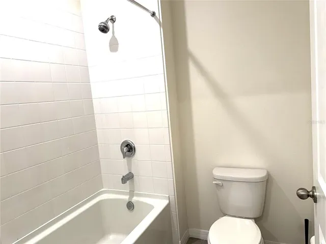 a view of an empty room with a staircase