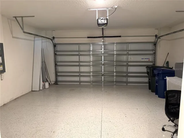 a view of a garden with a table and chairs in patio