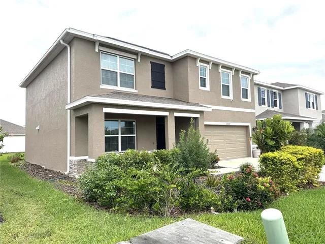 a front view of house with yard and trees