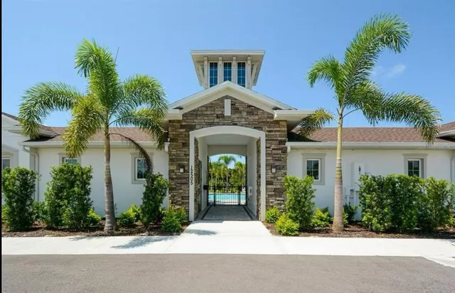 a front view of a house with a yard and parking