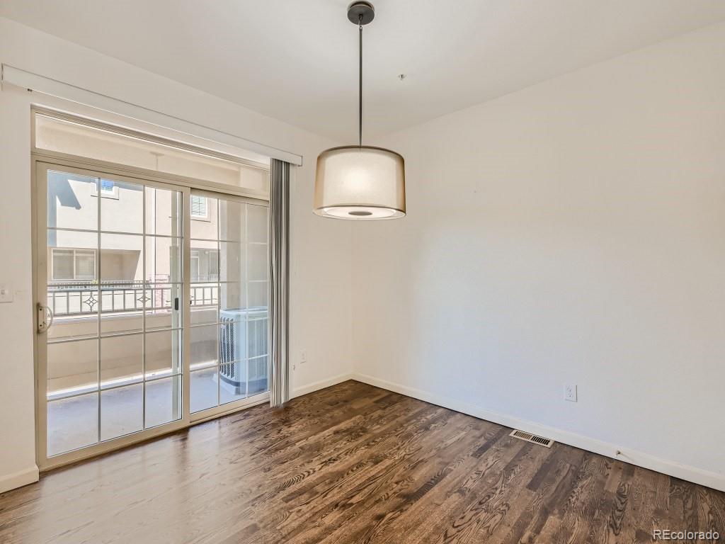 950 Elmhurst Drive, Unit E Highlands Ranch, CO 80129 - Photo 11 of 28 a room with wooden floor and windows