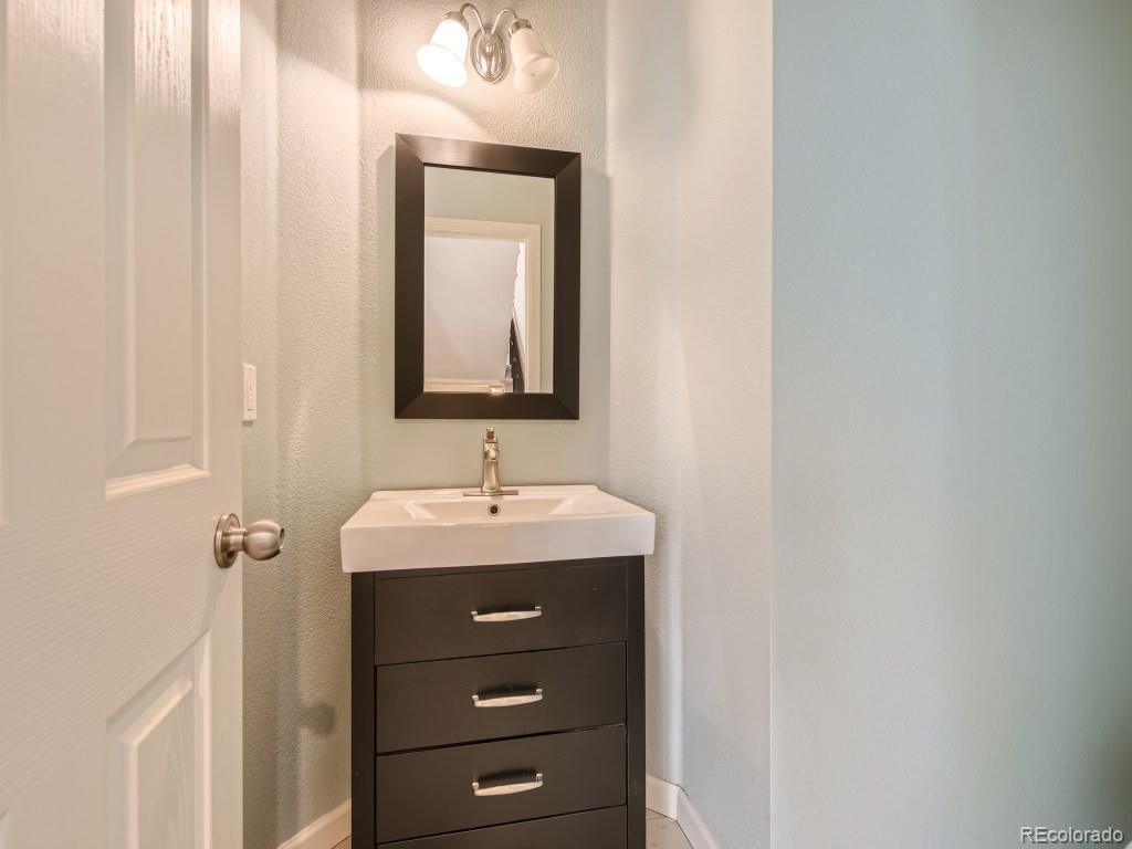 950 Elmhurst Drive, Unit E Highlands Ranch, CO 80129 - Photo 12 of 28 a bathroom with a sink and a mirror