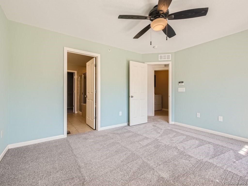 950 Elmhurst Drive, Unit E Highlands Ranch, CO 80129 - Photo 15 of 28 an empty room with chandelier fan