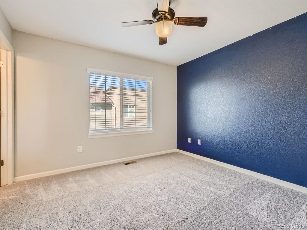 950 Elmhurst Drive, Unit E Highlands Ranch, CO 80129 - Photo 19 of 28 a view of an empty room with a window