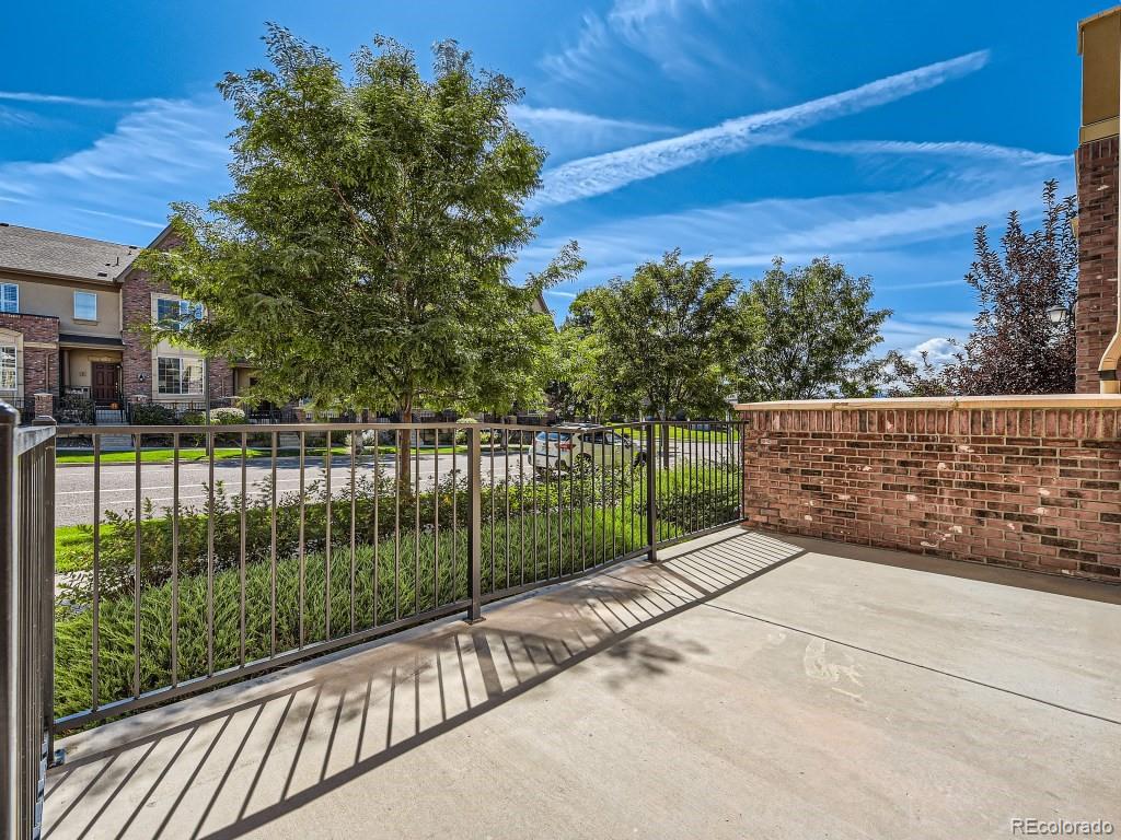 950 Elmhurst Drive, Unit E Highlands Ranch, CO 80129 - Photo 3 of 28 a view of a fence and trees from a balcony