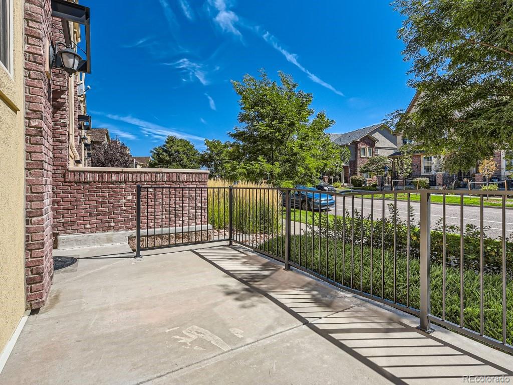 950 Elmhurst Drive, Unit E Highlands Ranch, CO 80129 - Photo 4 of 28 a view of a pathway with a wrought fence