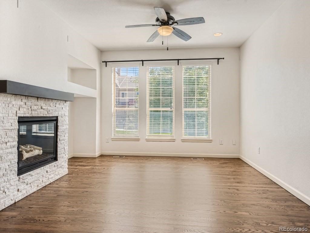 950 Elmhurst Drive, Unit E Highlands Ranch, CO 80129 - Photo 5 of 28 a view of room window and wooden floor