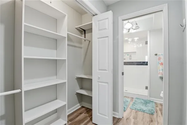 a view of walk in closet with empty racks