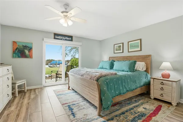 a bedroom with a large bed and a chandelier