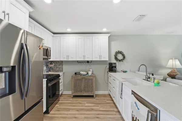 a kitchen with a sink stove and refrigerator