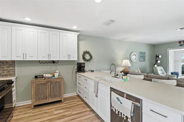 a kitchen with a sink stove and cabinets