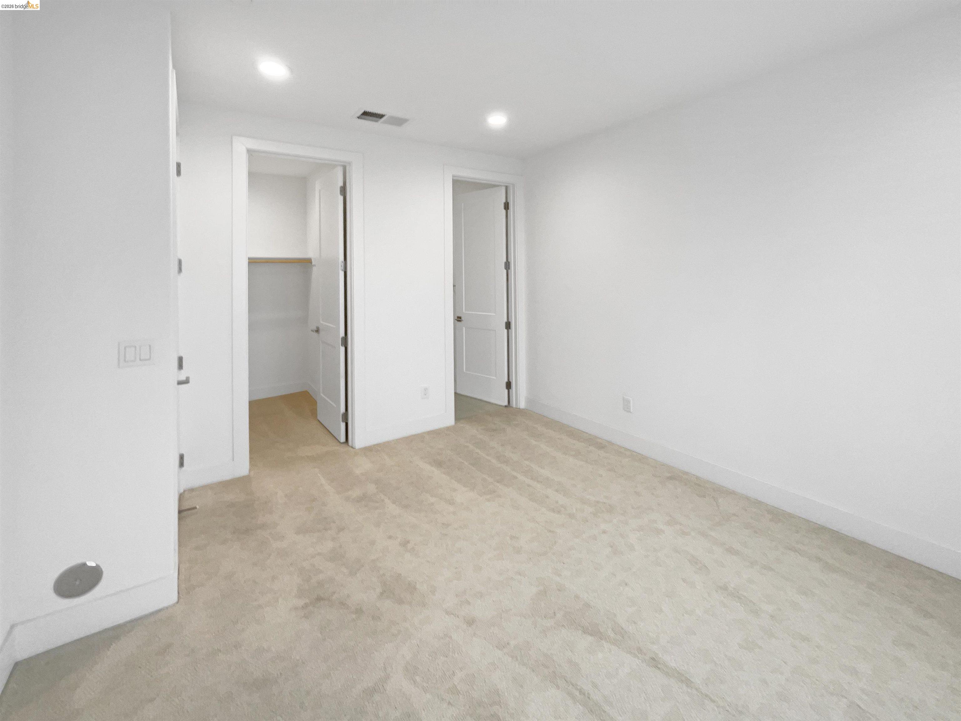 3419 Router Common Fremont, CA 94538 - Photo 10 of 26 Unfurnished bedroom featuring a walk in closet, recessed lighting, and light colored carpet
