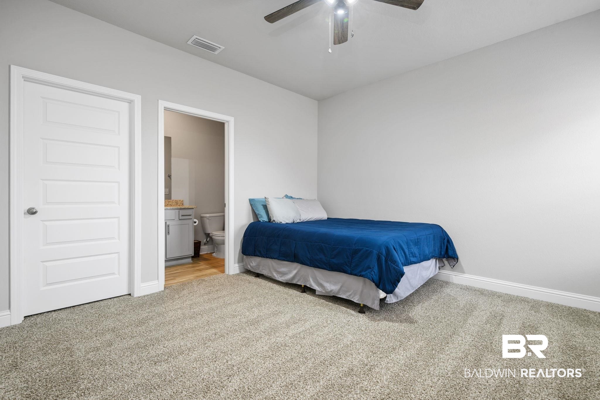 2183 Meadowview Loop Semmes, AL 36575 - Photo 27 of 58 Bedroom with light colored carpet, connected bathroom, and ceiling fan