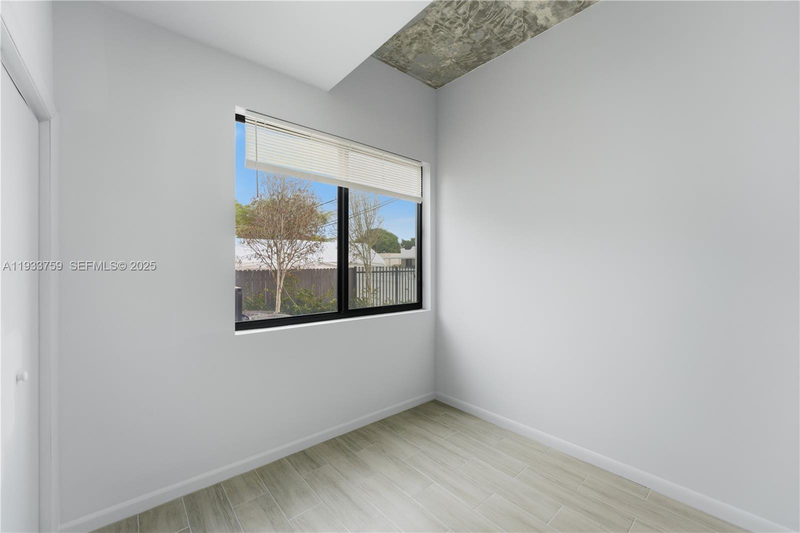 1393 Northwest 31st Street, Unit A Miami, FL 33142 - Photo 14 of 21 an empty room with a window