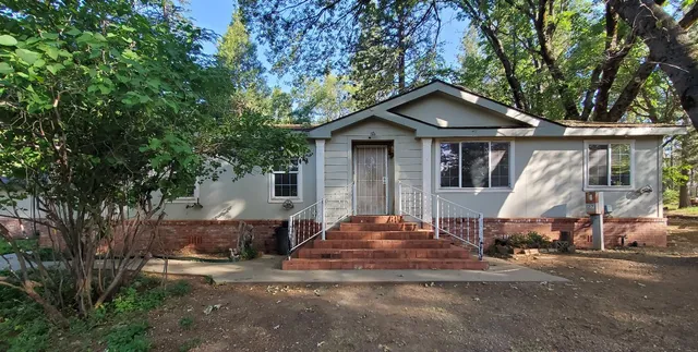 a backyard of a house with yard fire pit and outdoor seating