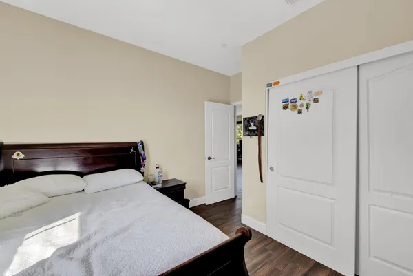 a large bed sitting in a bedroom and a table