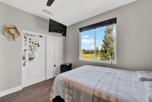 a bedroom with a bed and a night stand